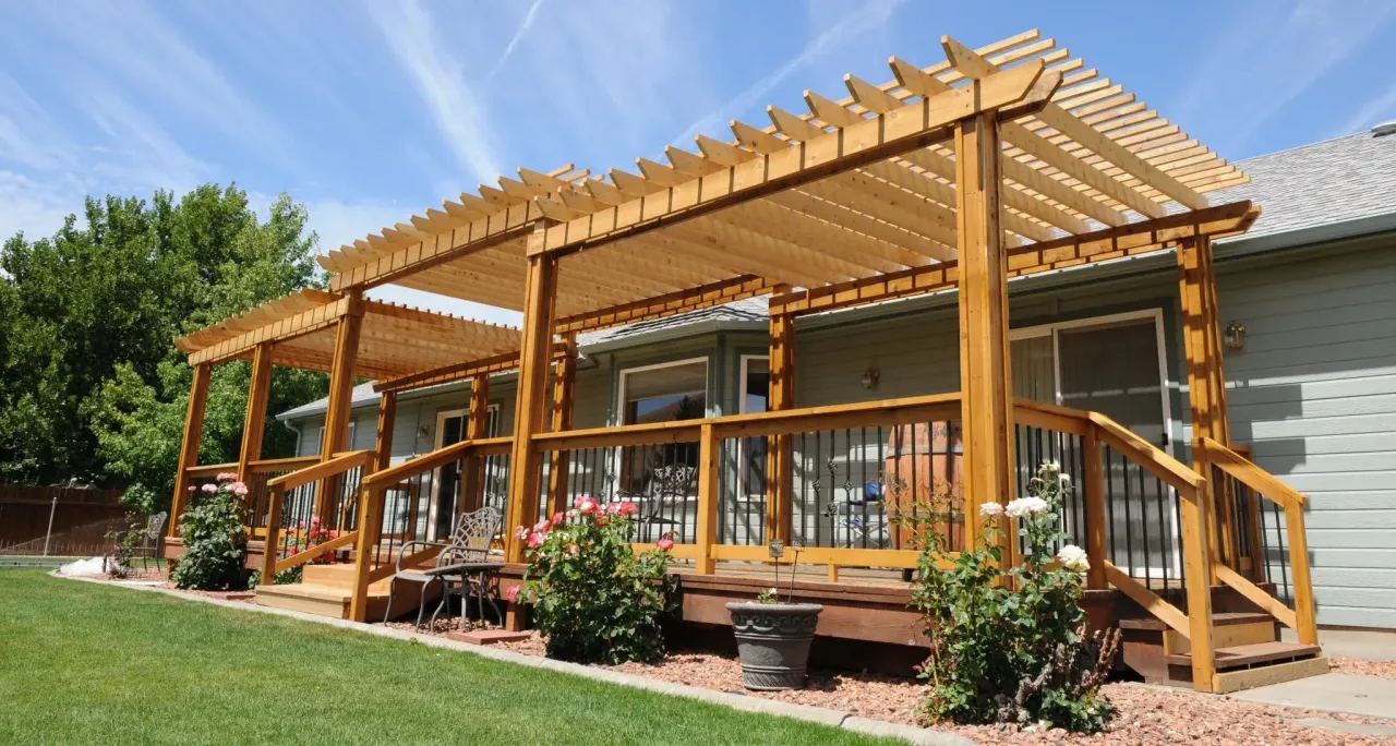 Custom wooden patio cover and pergola structure over a driveway
